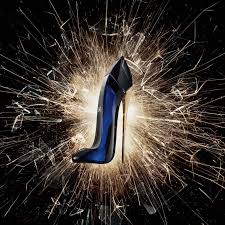 Blue high-heeled shoe with a sparkler effect on a dark background