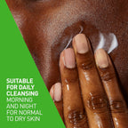 Hand applying cream to skin with a green background and text about skin care.