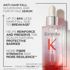 Kérastase serum bottle with text about anti-hair fall benefits on a white background